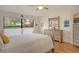 Bright bedroom featuring a comfortable bed, dresser, and large window offering natural light at 7363 Silver Fern Blvd # 80, Sarasota, FL 34241