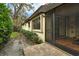 Exterior view featuring a screened-in porch and a well-maintained yard with manicured hedges at 7363 Silver Fern Blvd # 80, Sarasota, FL 34241