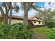 Charming home exterior showcasing mature trees and well-manicured landscaping at 7363 Silver Fern Blvd # 80, Sarasota, FL 34241
