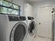 Laundry room with side by side Electrolux washer and dryer, and functional layout at 7363 Silver Fern Blvd # 80, Sarasota, FL 34241