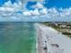Beautiful aerial shot of a busy beach with beachgoers enjoying the ocean and shoreline at 800 S Blvd Of Presidents # 12, Sarasota, FL 34236