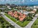 An aerial view of a neighborhood near the ocean, showcasing tile roofs and lush landscaping at 800 S Blvd Of Presidents # 12, Sarasota, FL 34236