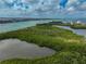 Scenic aerial shot of a waterway with a group of kayaks touring through a lush mangrove area at 800 S Blvd Of Presidents # 12, Sarasota, FL 34236