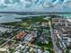 Stunning aerial view of a coastal community with a mix of residential homes and condos, lush green vegetation and water views at 800 S Blvd Of Presidents # 12, Sarasota, FL 34236