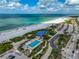 Wide angle shot of an oceanfront public beach, and pool with parking, featuring white sand at 800 S Blvd Of Presidents # 12, Sarasota, FL 34236