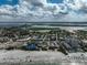 A panoramic aerial view showcases a beach and surrounding town with ocean views and local scenery at 800 S Blvd Of Presidents # 12, Sarasota, FL 34236