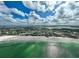 Breathtaking aerial view of a white sand beach meeting turquoise waters under a partly cloudy sky, beautiful tropical paradise at 800 S Blvd Of Presidents # 12, Sarasota, FL 34236