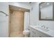 Bathroom with tiled walk-in shower, modern vanity with stylish mirror, and lighting at 800 S Blvd Of Presidents # 12, Sarasota, FL 34236