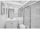 All-white bathroom with modern fixtures, featuring a large mirror, and glass enclosed shower at 800 S Blvd Of Presidents # 12, Sarasota, FL 34236