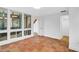 A bright room with terracotta floors, featuring a hallway leading to other areas of the house at 800 S Blvd Of Presidents # 12, Sarasota, FL 34236