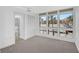 Bright bedroom features carpet, white walls, and expansive windows offering natural light at 800 S Blvd Of Presidents # 12, Sarasota, FL 34236