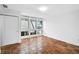 Bright bedroom features terracotta tile flooring, white walls, and expansive windows offering natural light at 800 S Blvd Of Presidents # 12, Sarasota, FL 34236
