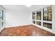 Sunlit room with terracotta tile floors, offering lots of light from the large windows at 800 S Blvd Of Presidents # 12, Sarasota, FL 34236