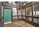 Inviting entryway with a modern, aqua-colored front door and multi-paned windows for ample natural light at 800 S Blvd Of Presidents # 12, Sarasota, FL 34236