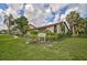Beautiful condo building with lush tropical landscaping, mature trees, and manicured lawns at 800 S Blvd Of Presidents # 12, Sarasota, FL 34236