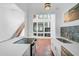 Well-lit kitchen featuring stainless steel appliances, sleek white countertops, and terracotta tile at 800 S Blvd Of Presidents # 12, Sarasota, FL 34236