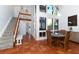 Open-concept living space with soaring ceilings, expansive windows, and terracotta tile flooring at 800 S Blvd Of Presidents # 12, Sarasota, FL 34236
