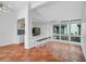 Open living area with a wet bar, breakfast bar, high ceilings, and abundant natural light at 800 S Blvd Of Presidents # 12, Sarasota, FL 34236