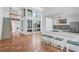 Open-concept living area showcasing terracotta tile, high ceilings, a wet bar, and natural light at 800 S Blvd Of Presidents # 12, Sarasota, FL 34236