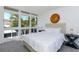 Serene main bedroom with bright light from large windows, a comfortable bed, and bedside tables at 800 S Blvd Of Presidents # 12, Sarasota, FL 34236