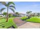 Charming single-story home with lush green lawn, swaying palm trees, and a driveway, creating curb appeal at 829 Harbor S Dr, Venice, FL 34285