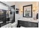 Modern bathroom with dark tile shower, marble countertop, a vessel sink, and stylish fixtures at 8388 Catamaran Cir, Lakewood Ranch, FL 34202