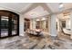 An expansive dining room featuring beautiful tile floors, statement mirror and modern chandelier at 8388 Catamaran Cir, Lakewood Ranch, FL 34202