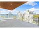 Expansive balcony showcasing breathtaking ocean views and a modern railing system on a bright sunny day at 111 Golden Gate Pt # 701Ph, Sarasota, FL 34236