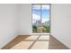 Bright bedroom features hardwood floors and a large window with city views at 111 Golden Gate Pt # 701Ph, Sarasota, FL 34236