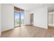 Bright bedroom features hardwood floors and a large window and ensuite bathroom at 111 Golden Gate Pt # 701Ph, Sarasota, FL 34236