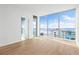 Beautiful bedroom features floor to ceiling windows and light colored hard wood floors at 111 Golden Gate Pt # 701Ph, Sarasota, FL 34236