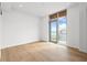 Bright bedroom features hardwood floors and a large window with beach views at 111 Golden Gate Pt # 701Ph, Sarasota, FL 34236