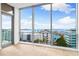 Floor to ceiling windows in a bright room with views of the coast at 111 Golden Gate Pt # 701Ph, Sarasota, FL 34236