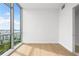 Bright bedroom features hardwood floors and a large window with city views at 111 Golden Gate Pt # 701Ph, Sarasota, FL 34236