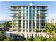 Modern condo exterior with floor-to-ceiling windows, offering stunning views and abundant natural light at 111 Golden Gate Pt # 701Ph, Sarasota, FL 34236