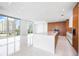 Open-concept kitchen featuring an island with white countertops and light wood cabinets at 111 Golden Gate Pt # 701Ph, Sarasota, FL 34236