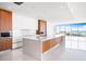 Modern kitchen features sleek cabinetry, large island with white countertop and stainless steel appliances at 111 Golden Gate Pt # 701Ph, Sarasota, FL 34236