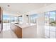 Bright, open-concept kitchen with white countertops and modern wood cabinets at 111 Golden Gate Pt # 701Ph, Sarasota, FL 34236