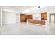 Open concept kitchen with sleek cabinets and a large center island at 111 Golden Gate Pt # 701Ph, Sarasota, FL 34236