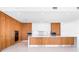 Spacious kitchen with modern wood cabinets, white countertops, and stainless steel appliances at 111 Golden Gate Pt # 701Ph, Sarasota, FL 34236