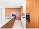 Modern kitchen featuring wood cabinets, white countertops, and stainless steel appliances at 111 Golden Gate Pt # 701Ph, Sarasota, FL 34236