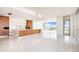 Bright, open kitchen with modern appliances, island, and a stunning water view at 111 Golden Gate Pt # 701Ph, Sarasota, FL 34236