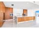 Kitchen with sleek wood and white cabinets and a large center island at 111 Golden Gate Pt # 701Ph, Sarasota, FL 34236