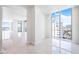 Spacious living room featuring an abundance of natural light and pristine white walls at 111 Golden Gate Pt # 701Ph, Sarasota, FL 34236