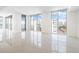 Bright living room with beautiful water views from the large windows at 111 Golden Gate Pt # 701Ph, Sarasota, FL 34236