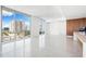 Bright open-concept living area with large windows overlooking the city and a modern kitchen at 111 Golden Gate Pt # 701Ph, Sarasota, FL 34236