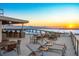 Relax on the rooftop lounge with outdoor seating and a bar, offering breathtaking views of the bay and sunset at 111 Golden Gate Pt # 701Ph, Sarasota, FL 34236