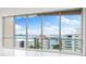 Expansive window showcasing waterfront views of the bridge and surrounding buildings at 111 Golden Gate Pt # 701Ph, Sarasota, FL 34236