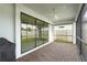 Covered patio area featuring a fan, brick pavers, and a large opening to the fenced backyard at 12409 Wigeon Dr, Bradenton, FL 34212