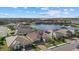 Aerial view of a residential community featuring homes surrounding a beautiful lake at 2028 Woodleaf Hammock Ct, Bradenton, FL 34211